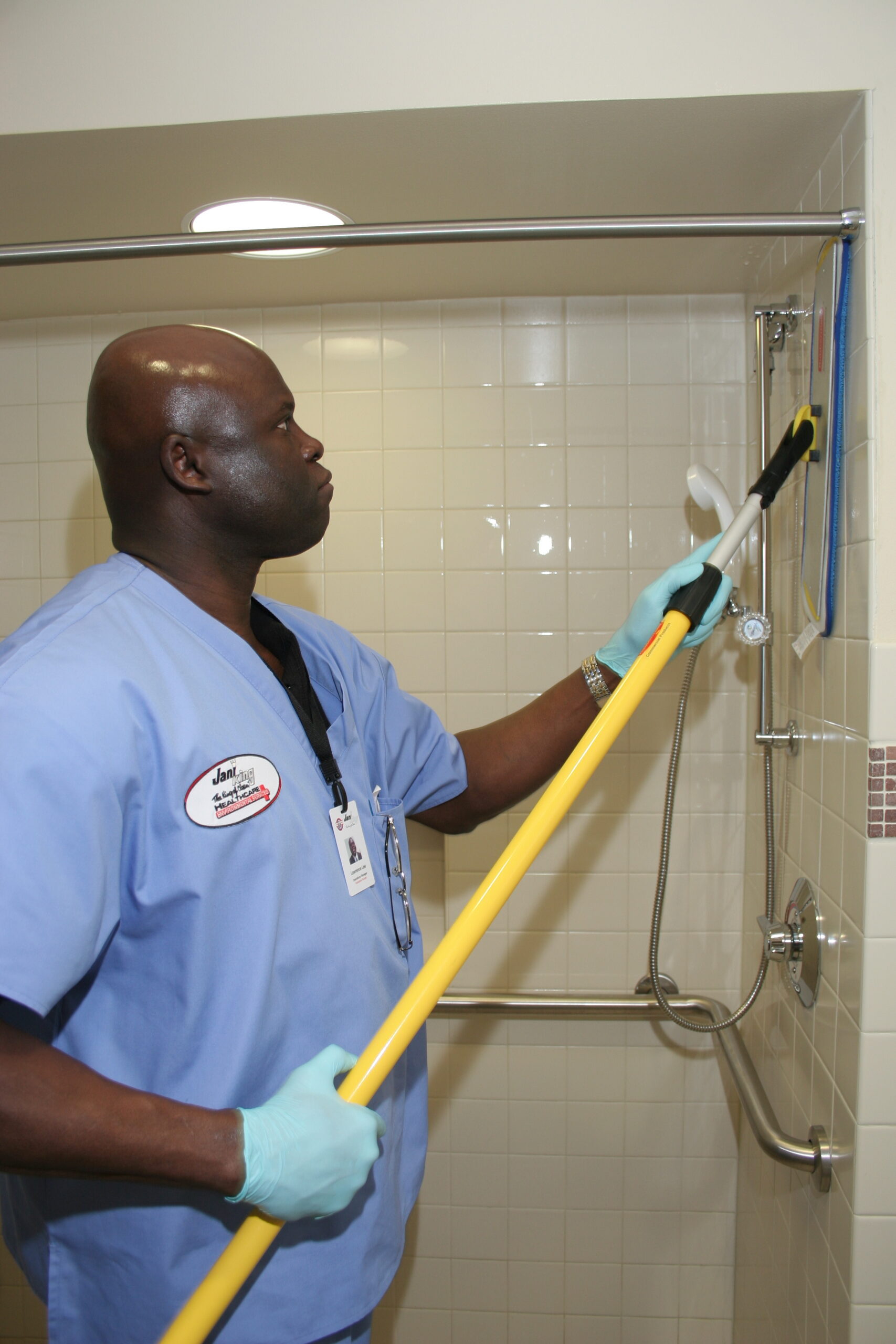 a man in scrubs his face with a brush