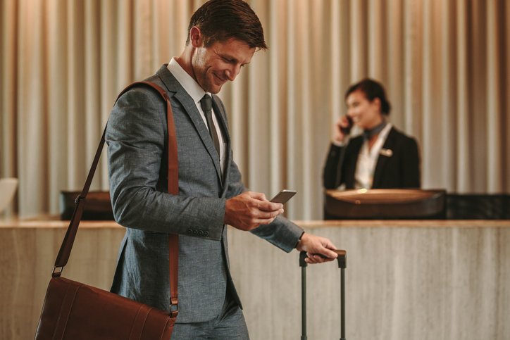 a man in a suit and tie is using his cell