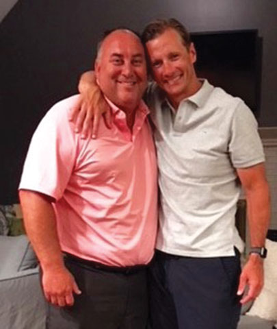 two men standing next to each other men