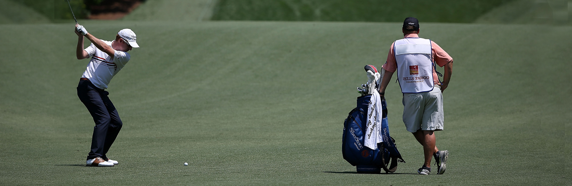 a man holding a golf bag