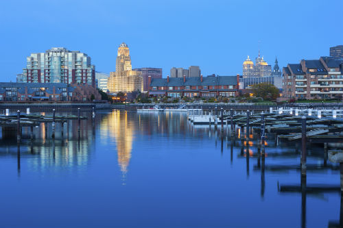 a city skyline with a body of water