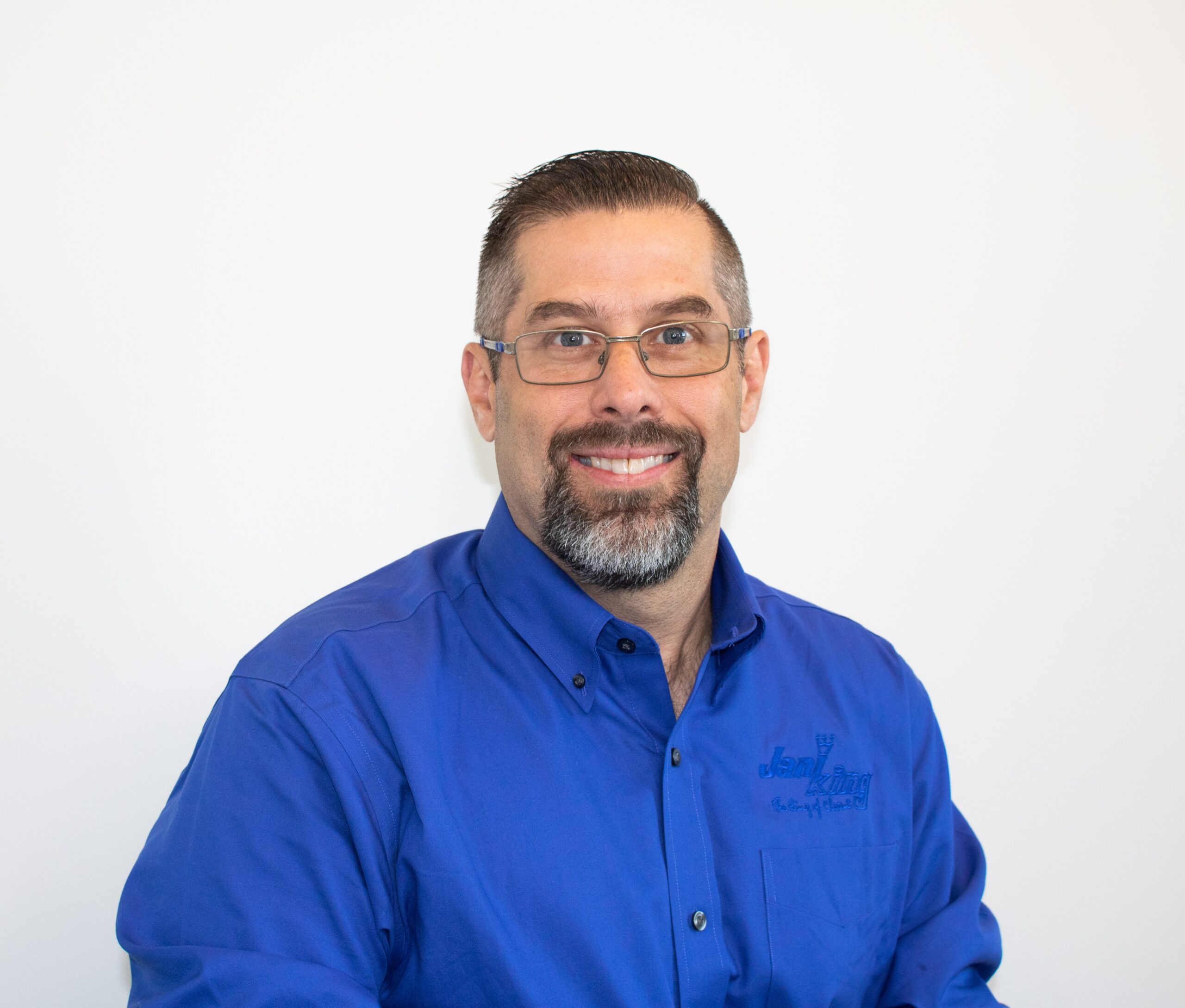 a man with glasses and a blue shirt