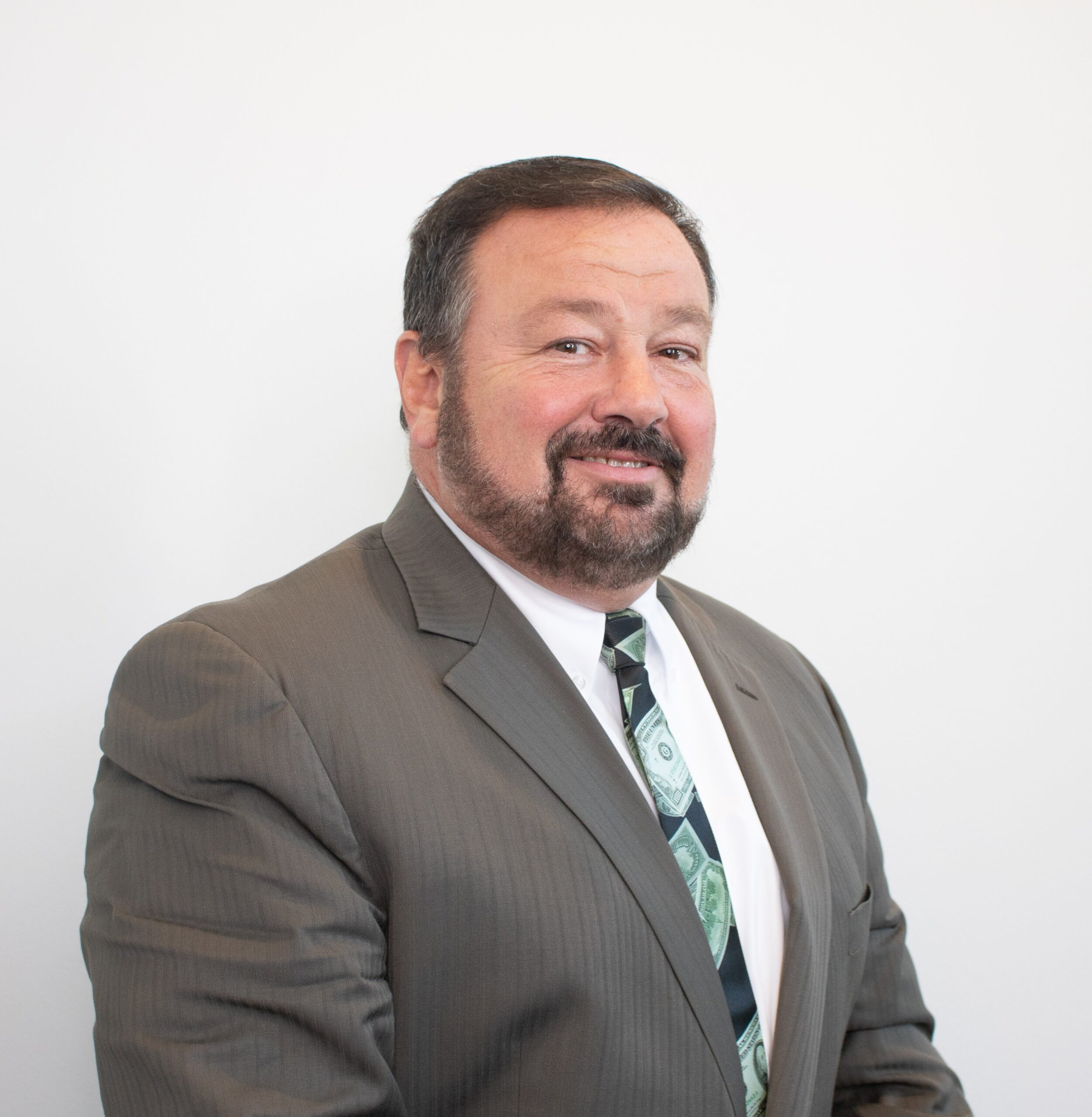 a man in a suit and tie with a beard