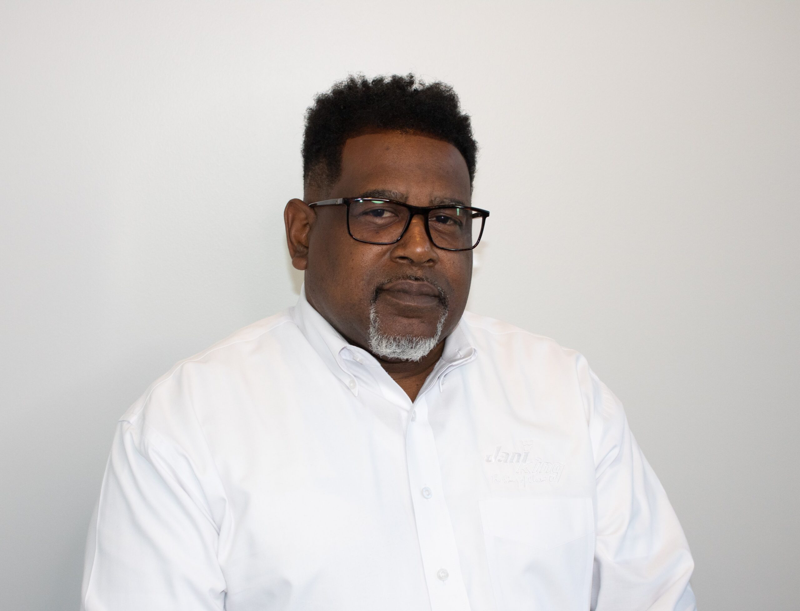 a man wearing glasses and a white shirt