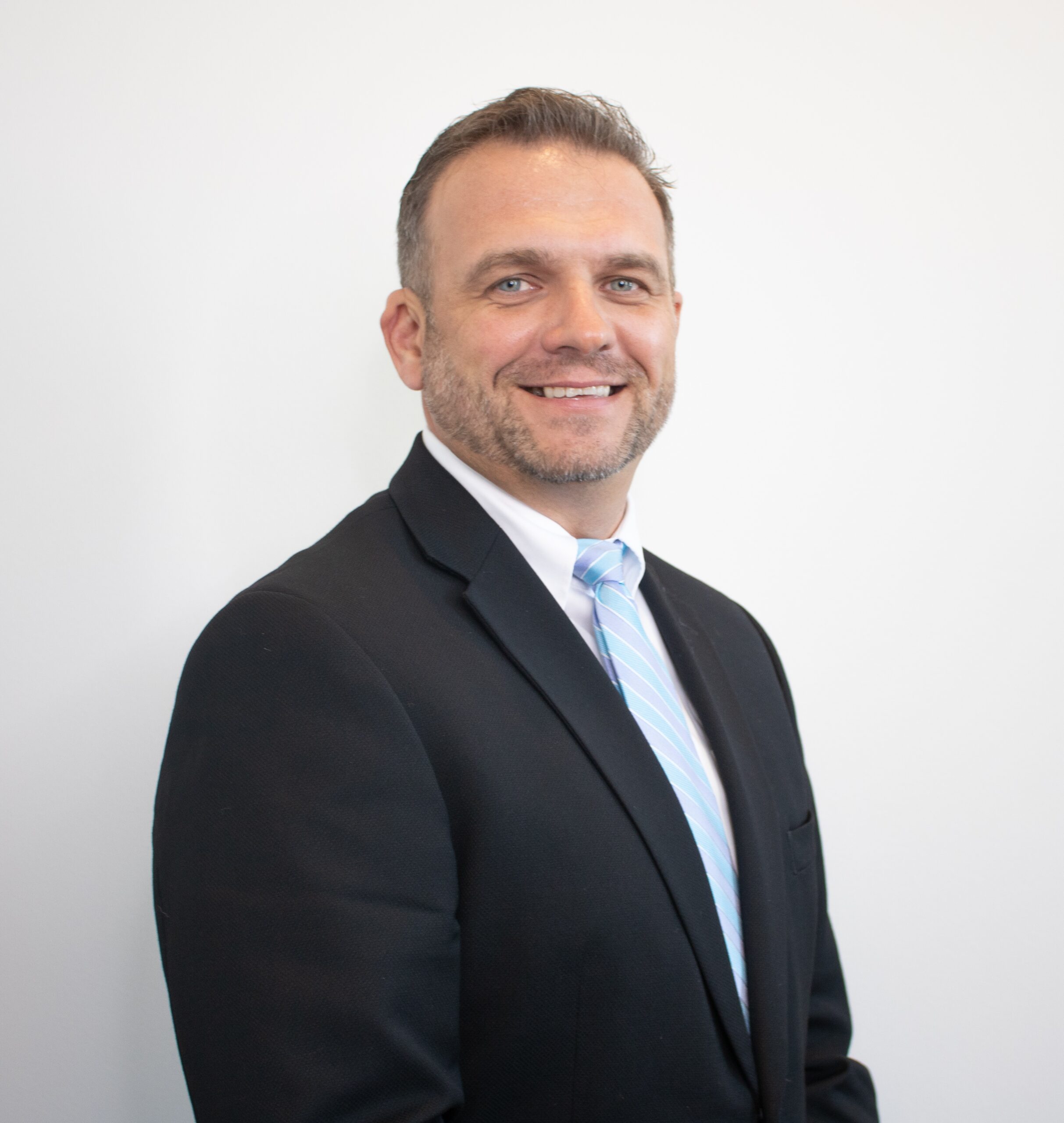 a man in a suit and tie smiling