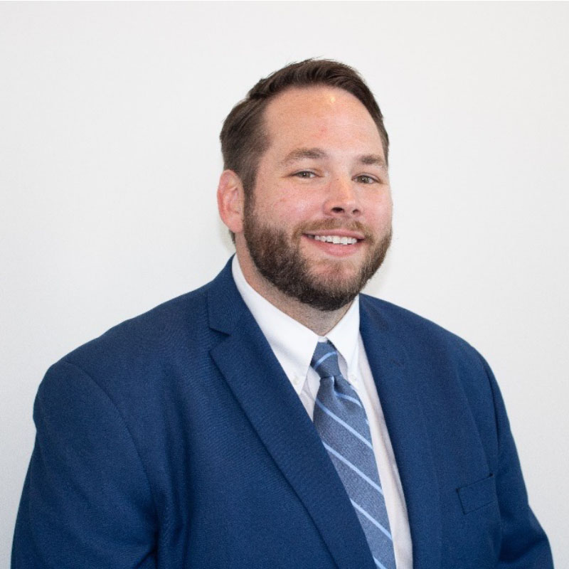 a man in a suit and tie smiling