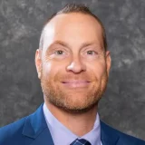 a man in a suit and tie smiling Scott Chamlee business headshot