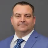 a man in a blue suit and tie William Tanner's professional headshot